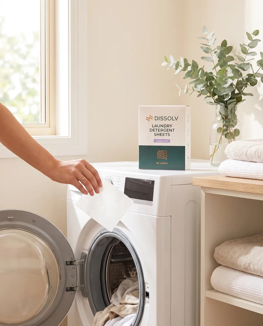 A DSSLV laundry detergent sheet going into the machine at home